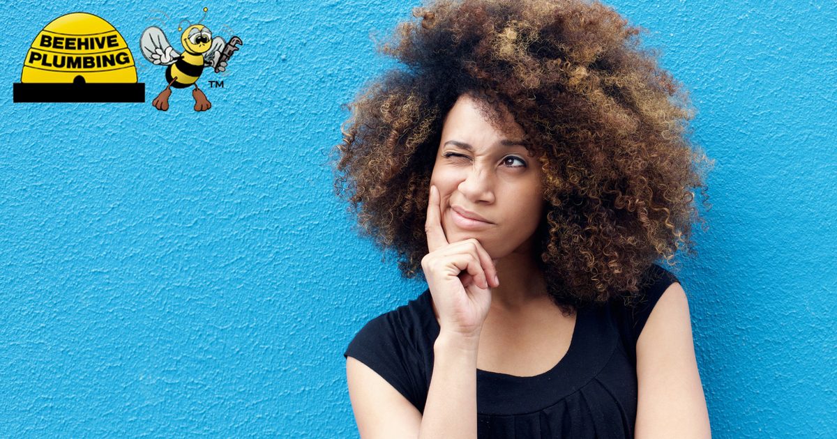 Woman Thinking Against Blue Wall Curly Hair - Solar Water Heater and Storage Tank Water Heater in Utah