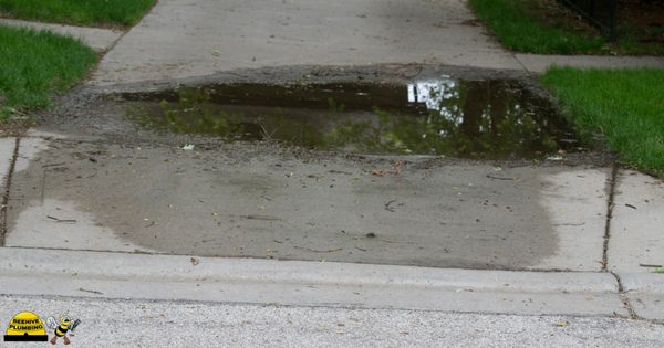 water on sidewalk due to leaky water main and residential plumbing problems