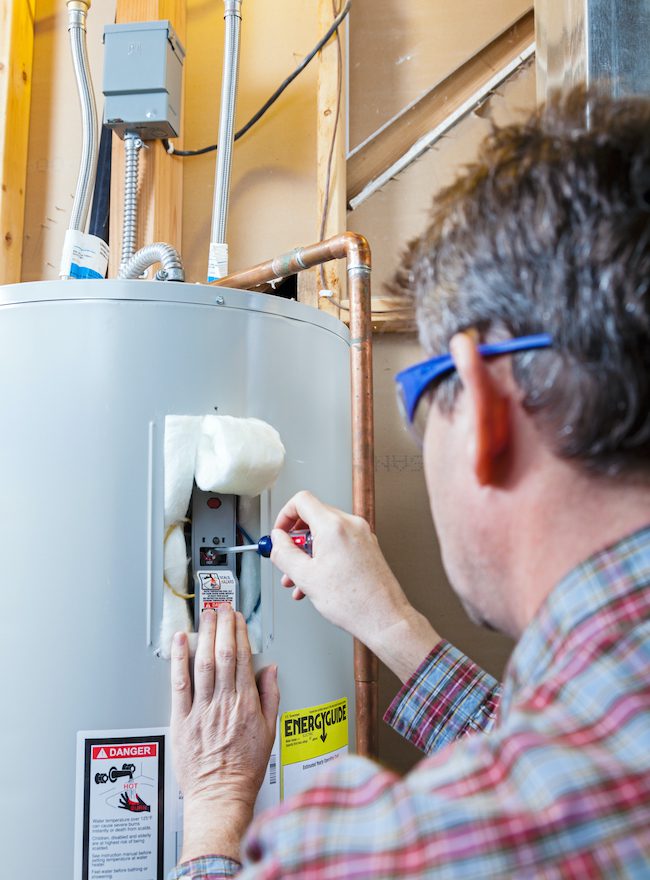 A technician performing water heater repair